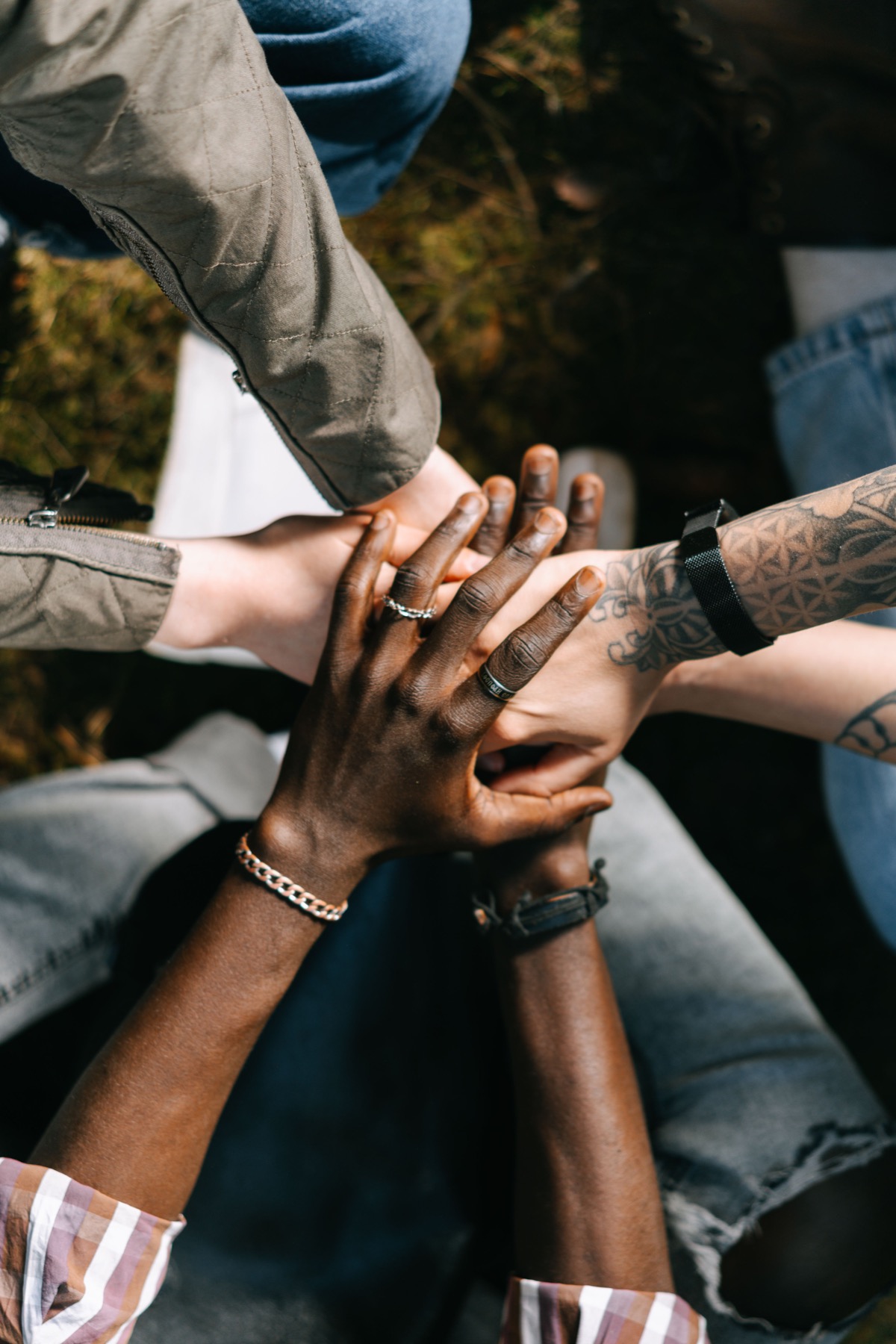 A group stacking hands in a gesture of connection and support
